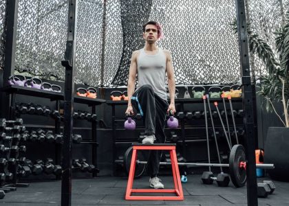 Adult male performing kettlebell exercises in a modern Mexico City gym.